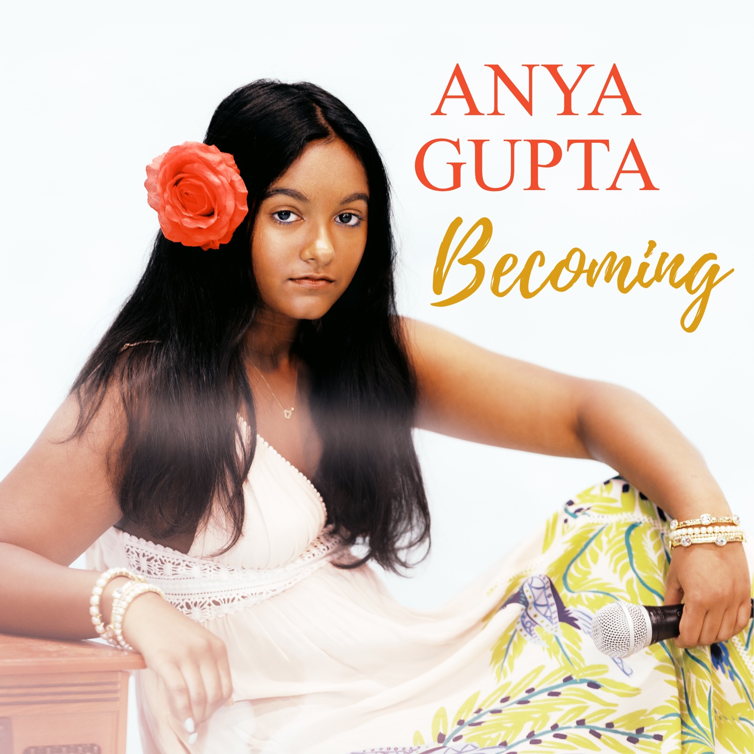 Becoming — debut album cover: Anya Gupta with a coral rose in her hair, holding a microphone