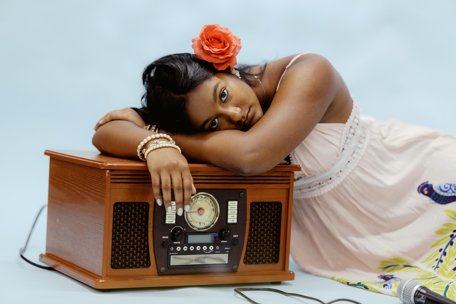 Anya resting her chin on her arms atop a vintage radio