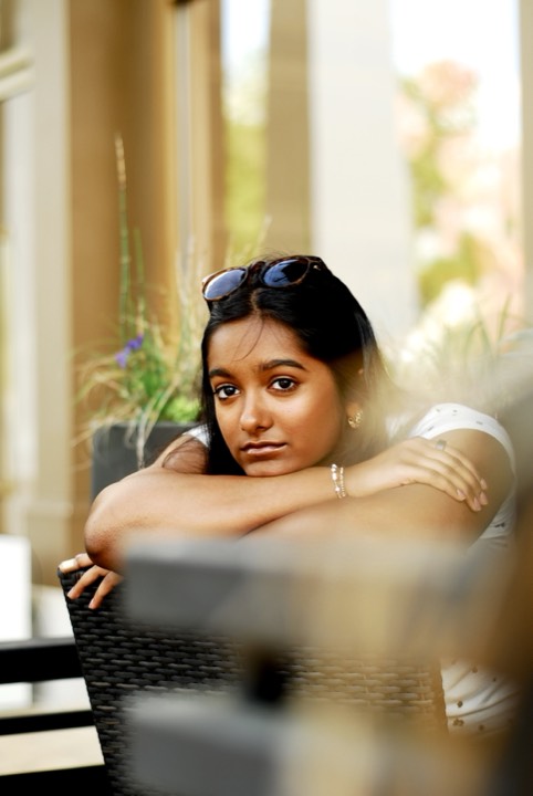 Anya resting her chin on her arms in golden-hour light, looking to camera